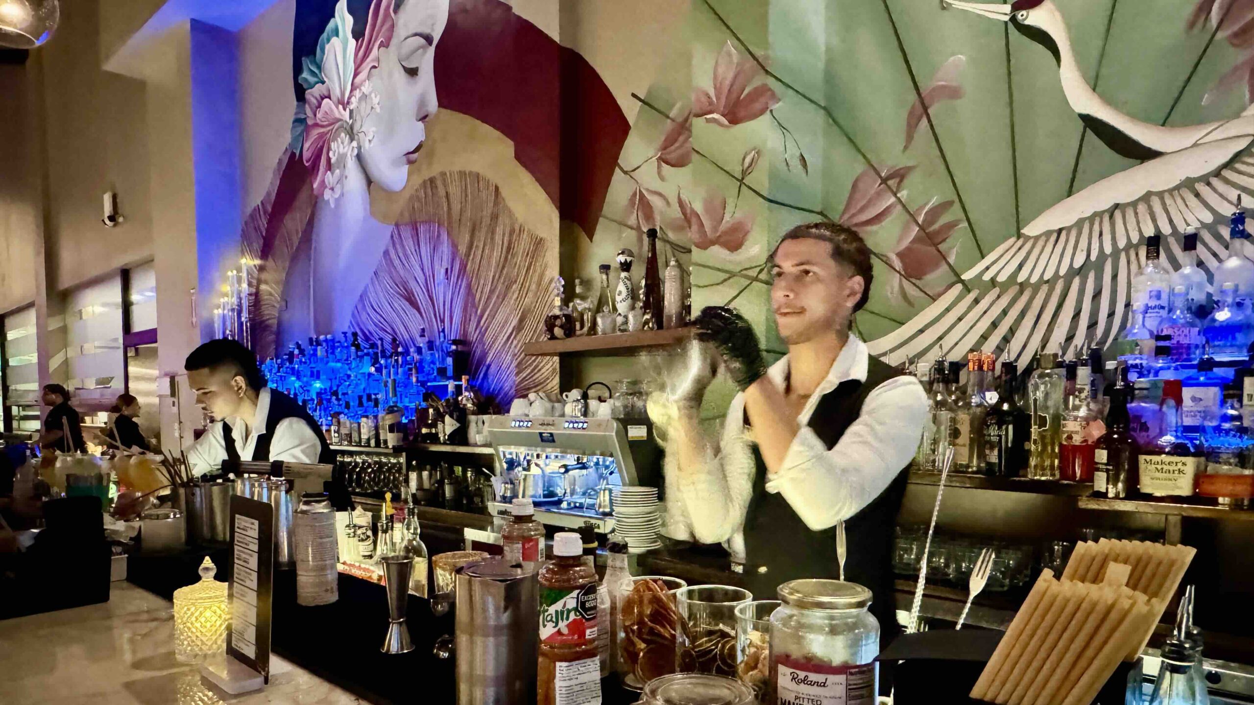 Mixologist hard at work mixing cocktails at Azia Restaurant & Lounge