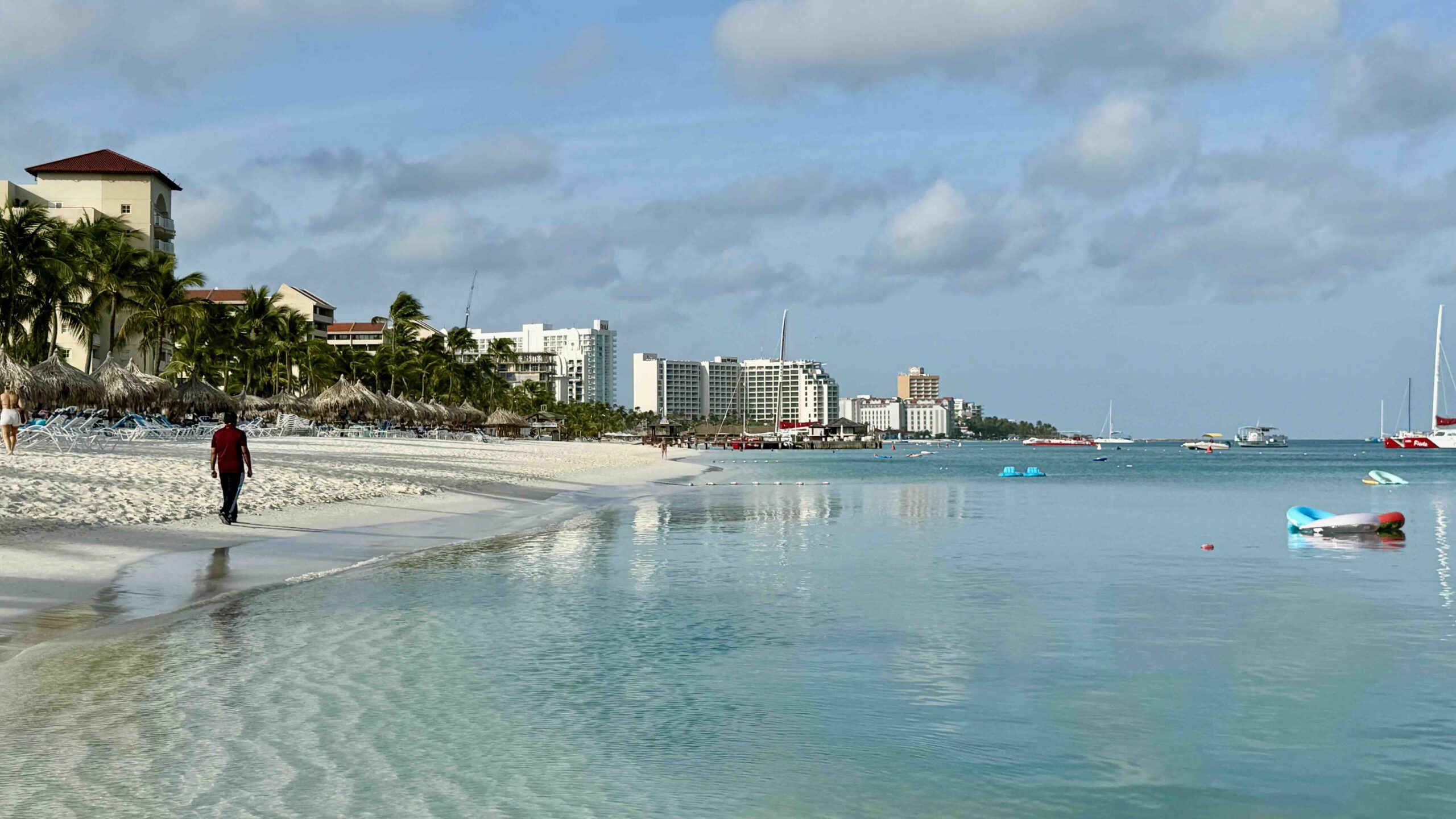 Palm Beach with woman walking on beach